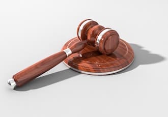 Wooden gavel on a white desk.